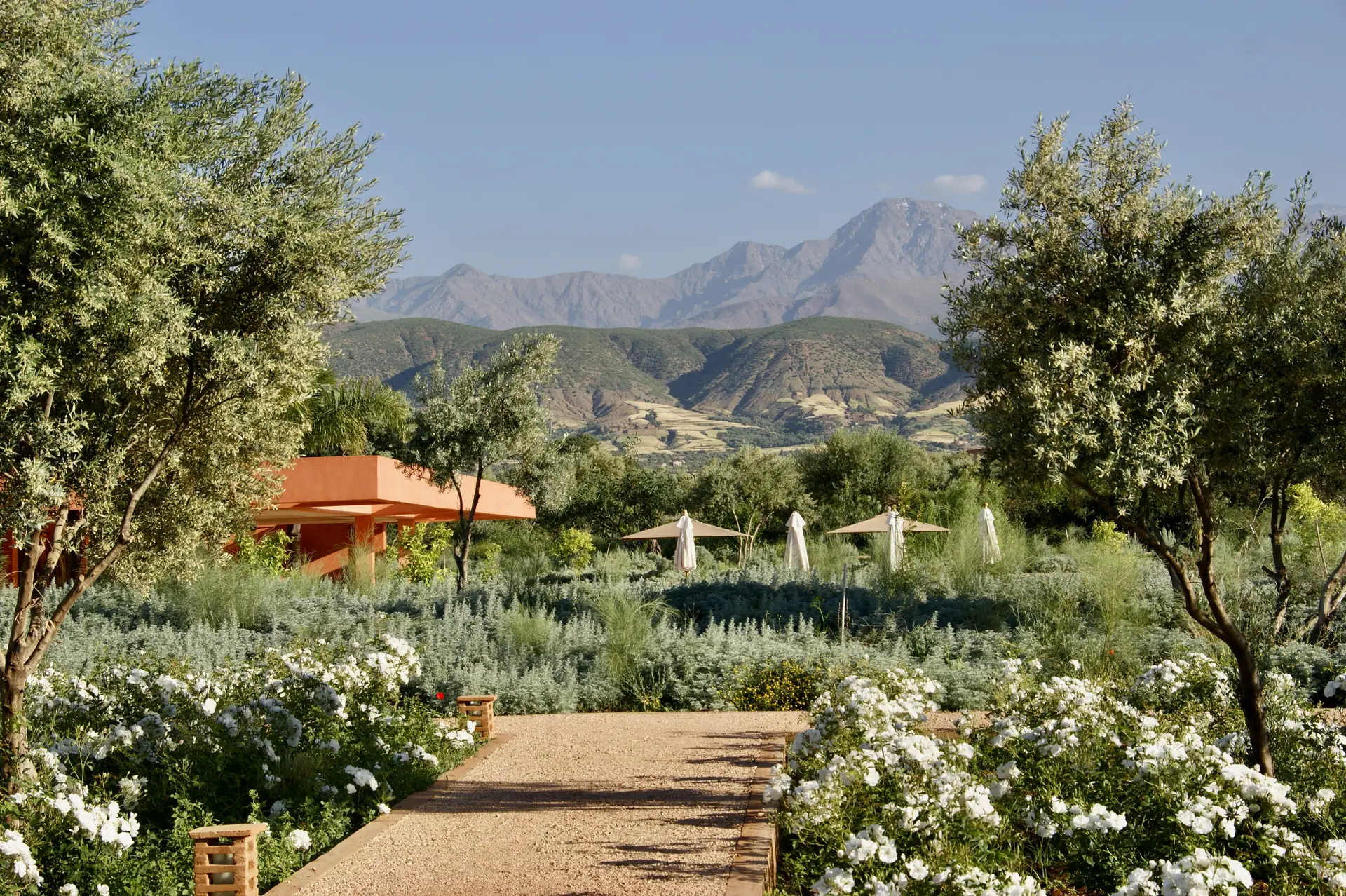 Flower-filled estate gardens with the Atlas Mountains beyond