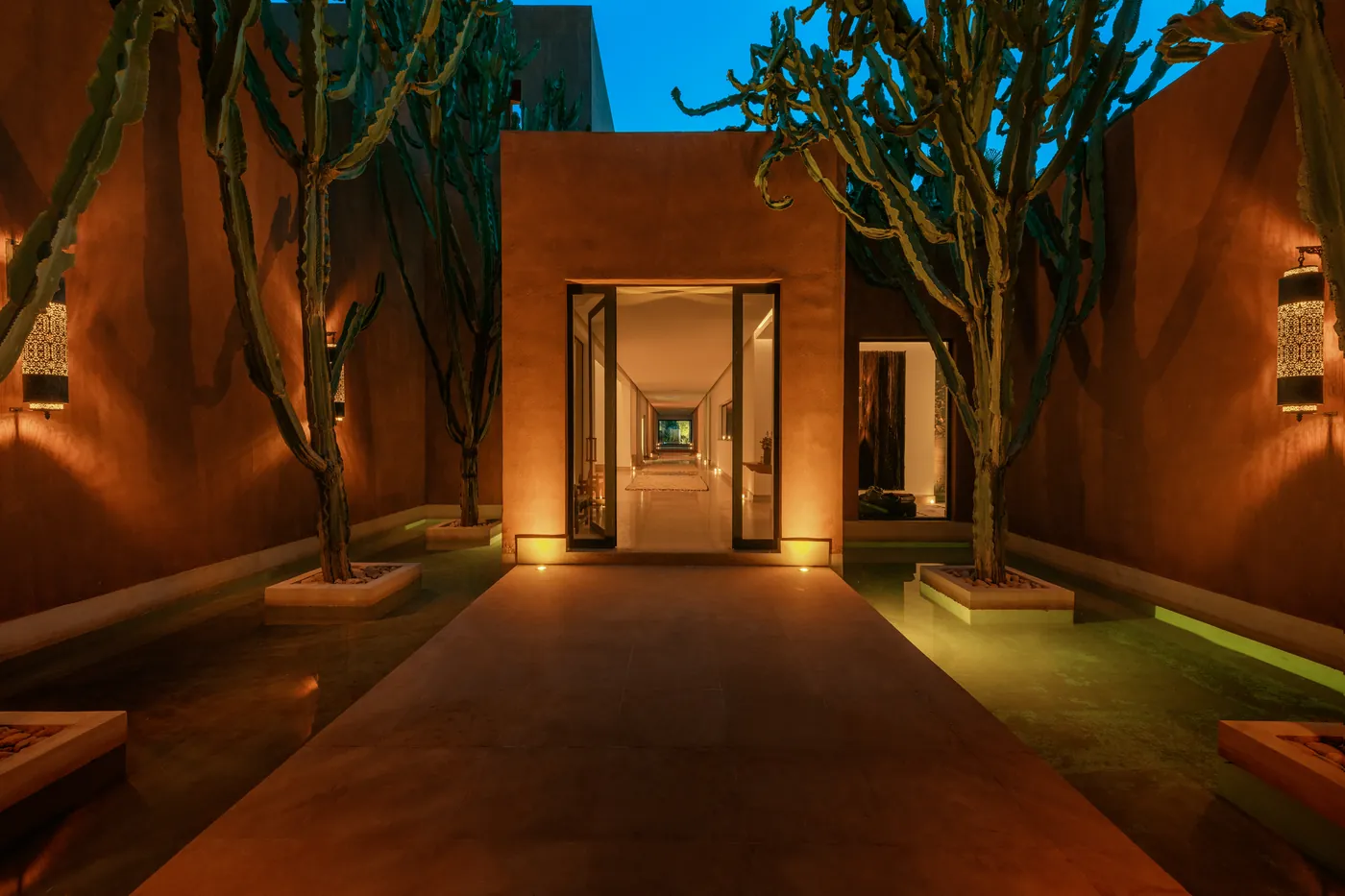 Lantern-lit entrance to the estate after dark