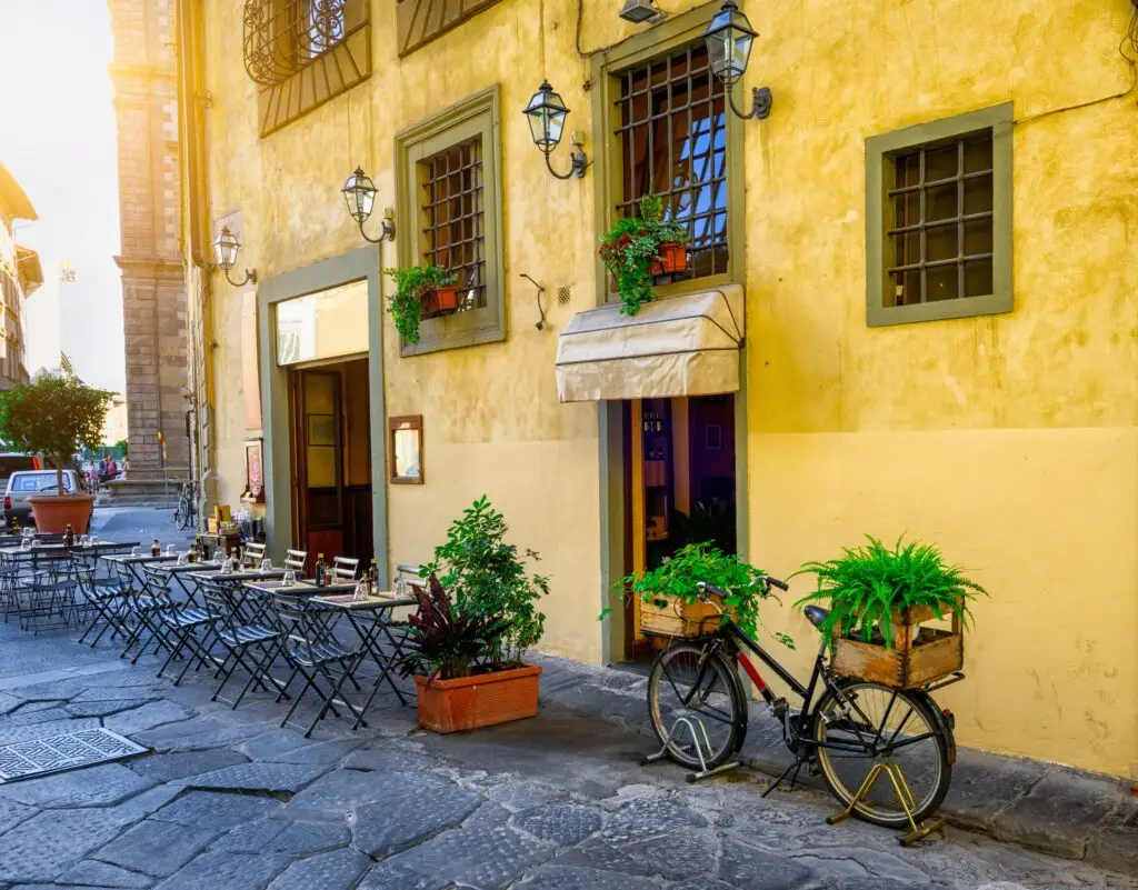 A flower-filled café street in Florence