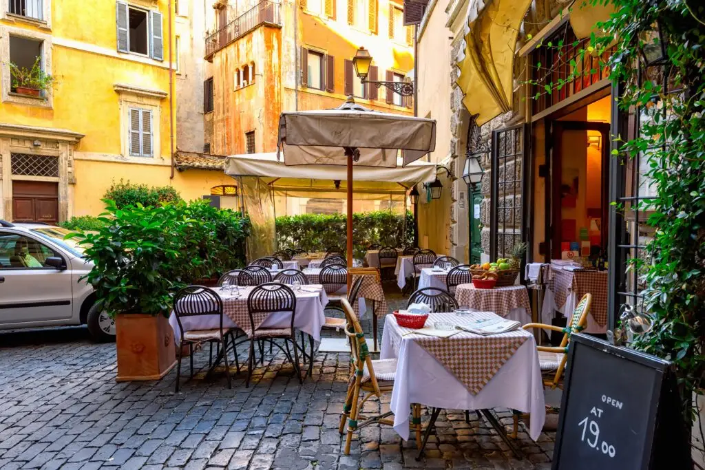 Tables outside a restaurant on a characterful street in Rome